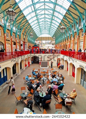 London, United Kingdom - April 21, 2012 : Covent Garden enclosed market with cafes and restaurants with a lot of shopping people inside