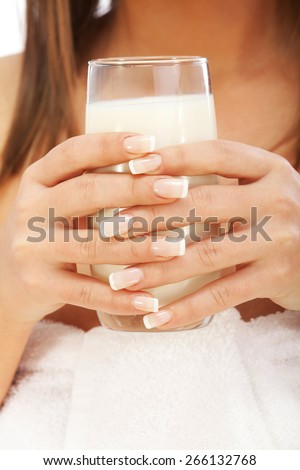 Woman drinking milk looking at camera, isolated on white background with copy space