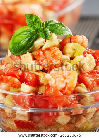 Tomato, shrimps and avocado salad, two portions, decorated with fresh basil