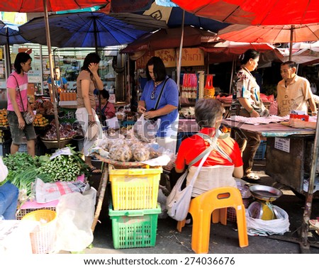 Chiang Mai, Thailand - March 06, 2011 : Thai people selling fresh vegetables in a local market