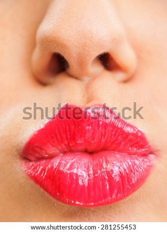 Attractive woman lips with red lipstick, close up