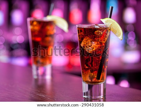 Long island iced tea cocktail shot on a bar counter