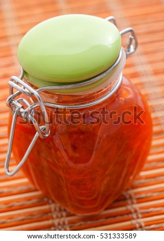 Jar with fruit jam shot from above. Vertical shot