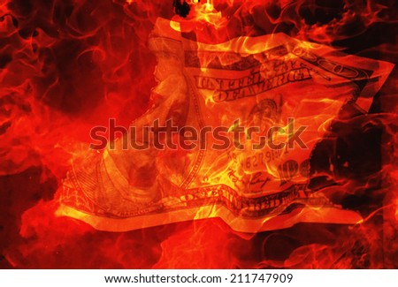 burning dollar bill as a symbol of inflation and the financial crisis