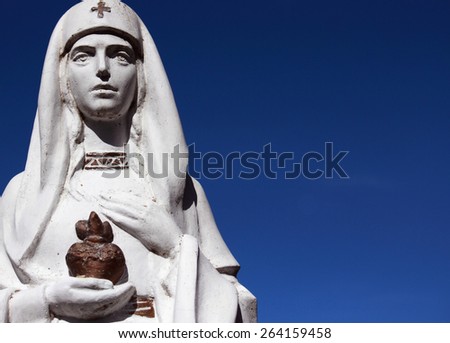 Nurse holding heart in hands as a symbol of health and medicine (statue)