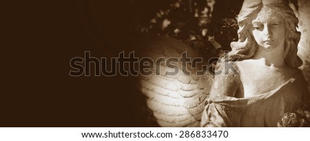 sculpture of a beautiful angel on  dark background (details)