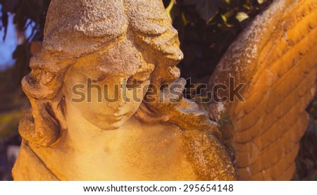 sculpture of an angel with dark background