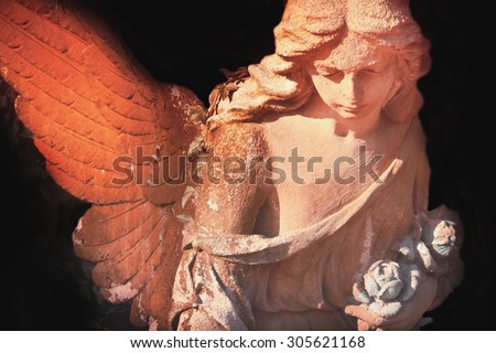 sculpture of an angel with dark background (details)