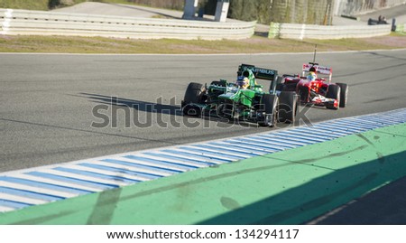 JEREZ, SPAIN - FEB 10: Charles Pic testing his new Caterham F1 car with Fellipe Massa driving his Ferrari in the distance on the first Test at the Jerez Circuit, Andalucia Spain 2013.