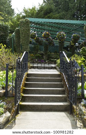 Steps leading to outdoor garden with hanging flower baskets