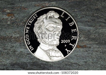 Fine Lincoln Silver Dollar on Natural Stone Background