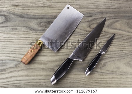 Butcher, paring and large knife set on fading white ash wood