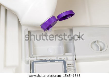 Horizontal photo of detergent being poured into dishwasher soap dispenser