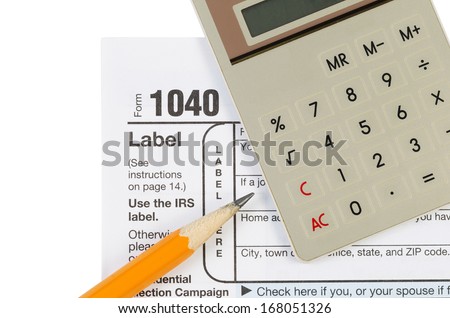Horizontal photo of United States Tax Form 1040 for Individual Income with Calculator and pencil isolated on white