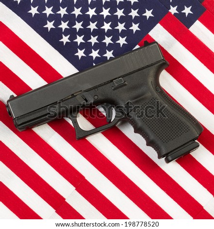 Photo of personal carry weapon with United States of America flags in background