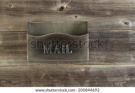 Overhead view of empty old metal mailbox on rustic wooded boards