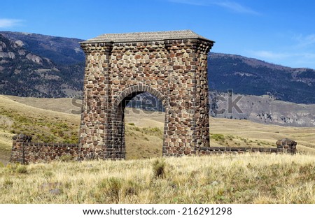 Closeup horizontal image of Yellowstone National Park Roosevelt Stone Arch at the North entrance in Montana with blue skies and clouds