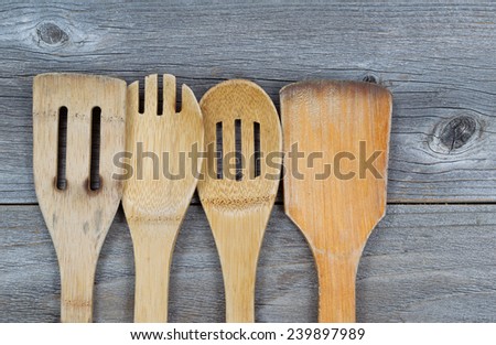 Horizontal image of old wooden cooking utensils on rustic wood