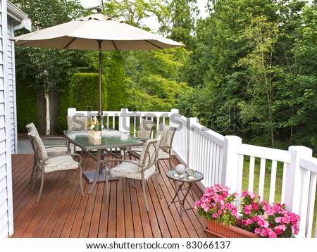 Outdoor patio setup on cedar wood deck  with trees in background