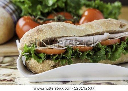 close up of a turkey sub with tomato, lettuce and cheese