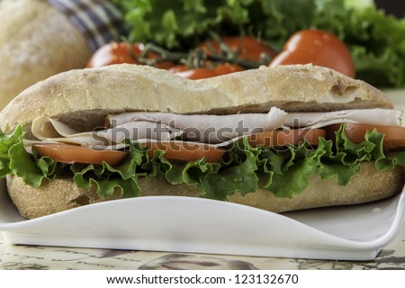 close up of a turkey sub with tomato, lettuce and cheese