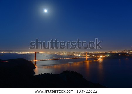 Golden Gate Bridge at full moon night, with San Francisco city skyline at back ground, San Francisco, California, USA
