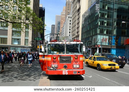 NEW YORK CITY - MAY 7: Red Fire Truck on duty at Fifth Avenue in Manhattan on May 7th, 2013 in New York City, USA