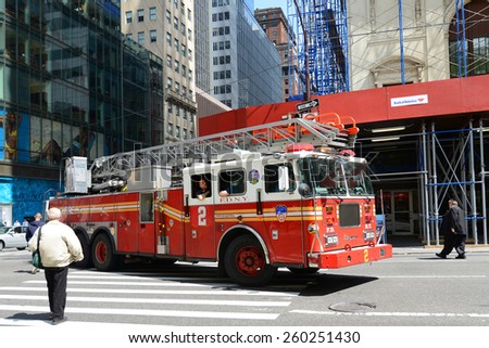 NEW YORK CITY - MAY 7: Red Fire Truck on duty at Fifth Avenue in Manhattan on May 7th, 2013 in New York City, USA