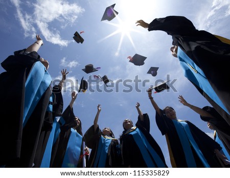 Students Throwing Graduation Hats In The Air Celebrating