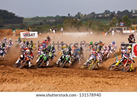 SI RACHA, THAILAND - MAR. 10 : Group of motocross riders at first curve during MX1/2 super final race of The FIM Motocross World Championship Grandprix of Thailand, on March 10, 2013. Thailand.