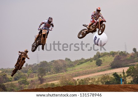 SI RACHA, THAILAND - MAR. 10 : Group of motocross riders jumping during MX1/2 last chance race of The FIM Motocross World Championship Grandprix of Thailand, on March 10, 2013. Thailand.