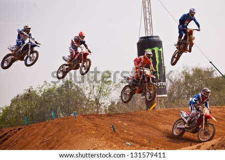 SI RACHA, THAILAND - MAR. 10 : Group of motocross riders jumping during MX1/2 last chance race of The FIM Motocross World Championship Grandprix of Thailand, on March 10, 2013. Thailand.