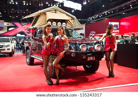 NONTHABURI, THAILAND - MARCH 26 : Unidentified modelling post over Isuzu Off Road camping truck showed in 34th Bangkok International Motor Show on March, 2013 in Nonthaburi, Thailand.