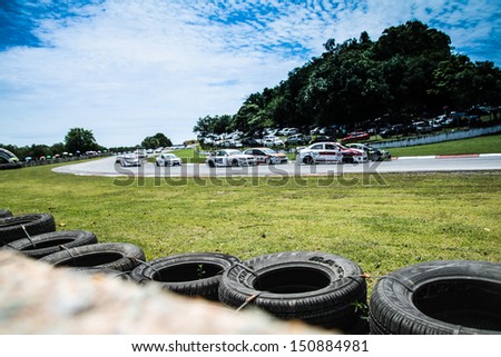 PATTYA, THAILAND-AUG.18 : Group of racing cars at 1st lap in Super 2000 series during the Thailand Super Series Round 3-4 at Bira International Circuit on August 18, 2013 in Pattaya, Thailand