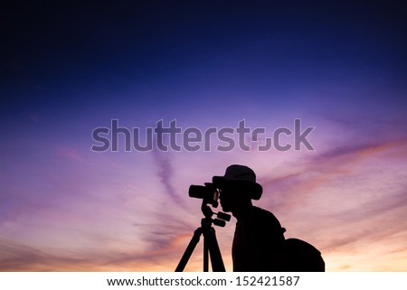 silhouette landscape photographer in back light.