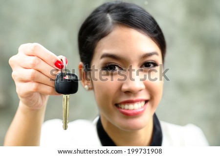 Pretty girl with car key in her hand