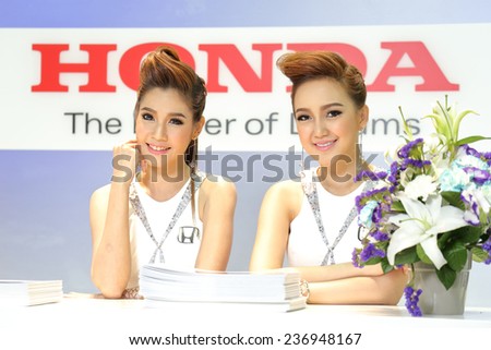 BANGKOK - DECEMBER 9 : pretty models posed over logo of Honda displayed on stage in Motor Expo 2014, on dec. 9, 2014 in Bangkok, Thailand.
