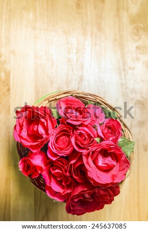 Top view of red roses on the top of wooden desk top, romantic still life.