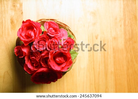 Top view of red roses on the top of wooden desk top, romantic still life.
