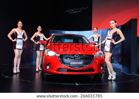 BANGKOK, THAILAND - MARCH 24 : The new Mazda 2 and super models displayed on stage at the 36th Bangkok International Motor show  in March 24, 2015. Bangkok, Thailand