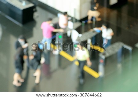 Blurry image from top view of lobby office building. Movement of businessman and businesswoman.