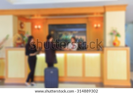 Blurry image of reception counter in hotel.