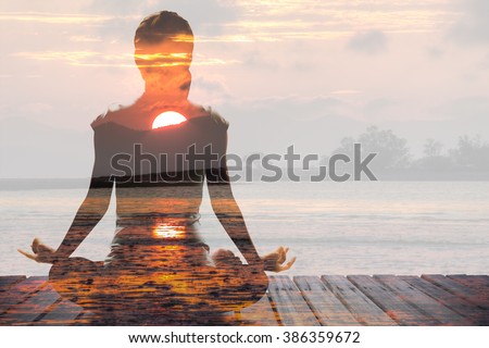 Silhouette of Asian woman yoga on the beach at the sunrise in the morning. Image by double layer technique create for business, healthcare, sport and lifestyle of people.,