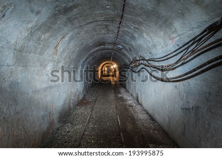 concrete tunnel in copper mine, low voltage wires on wall