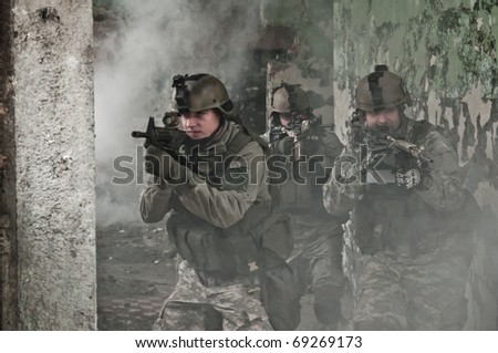 Young soldiers on patrol in smoke