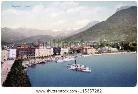 SWITZERLAND - CIRCA 1918: a postcard printed in SWITZERLAND shows bird\'s-eye view of Swiss town Lugano in the Italian-speaking canton of Ticino, circa 1918.