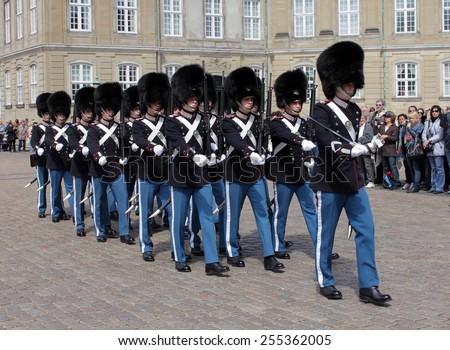 DENMARK, COPENHAGEN - MAY 15, 2012: Royal guards at Amalienborg Slot in Copenhagen. This palace is the home of the Danish royal family and a top tourist attraction as well, 15 of May, 2012.