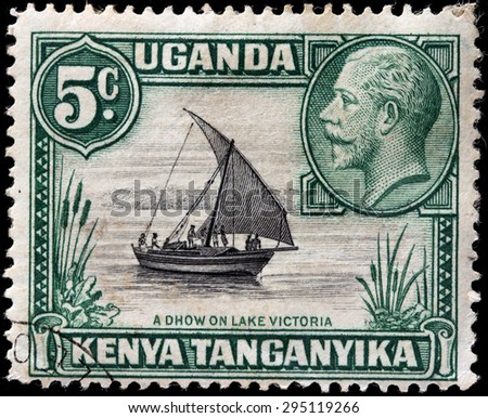 EAST AFRICAN COMMUNITY - CIRCA MAY, 1935: A stamp printed by EAST AFRICAN COMMUNITY shows portrait of King George V against traditional sailing vessel Dhow on Lake Victoria