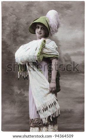 FRANCE - CIRCA 1906: a vintage postcard printed in France shows hand painted photograph of beautiful lady in fashion dress of 1906. Circa 1906.