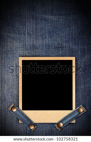 Blank instant photo frames on blue jeans background